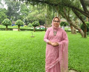 Photo of Afia Rahman Mukta on a green lawn in front of a hanging tree