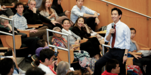 Pita stands in the middle of rows of students while giving his study group talk